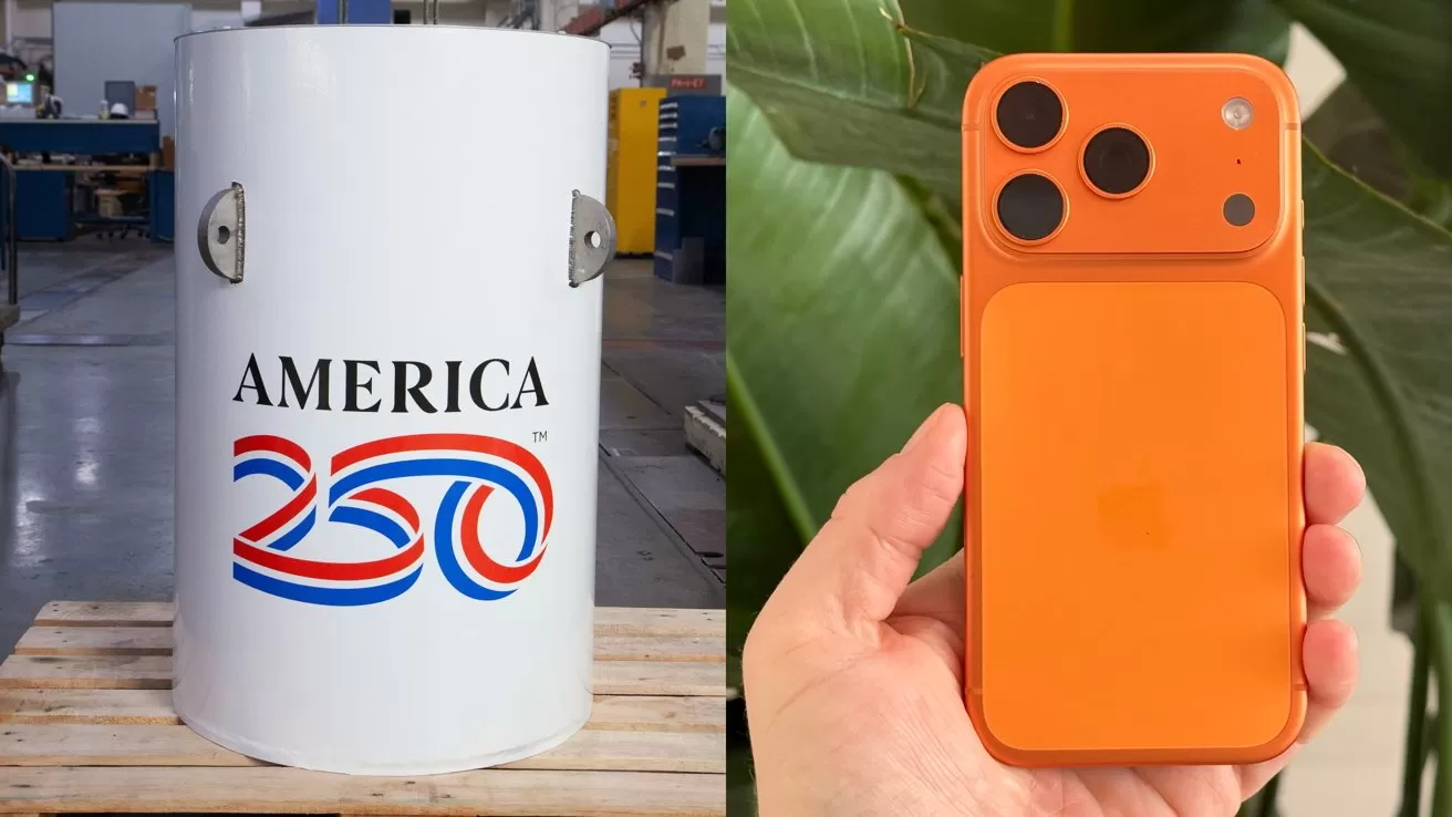 White cylindrical object with America 250 logo in a workshop beside a hand holding an orange smartphone with three rear cameras against large green leaves background